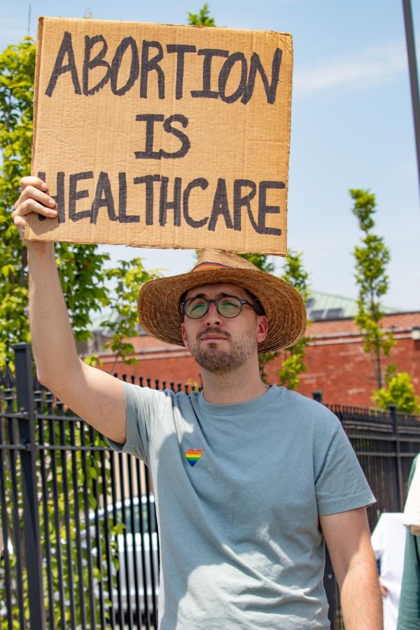 A participant carries a sign that says, Abortion is Healthcare, during the Bans Off Our Bodies March May 14, 2022 in Carbondale, Ill. 