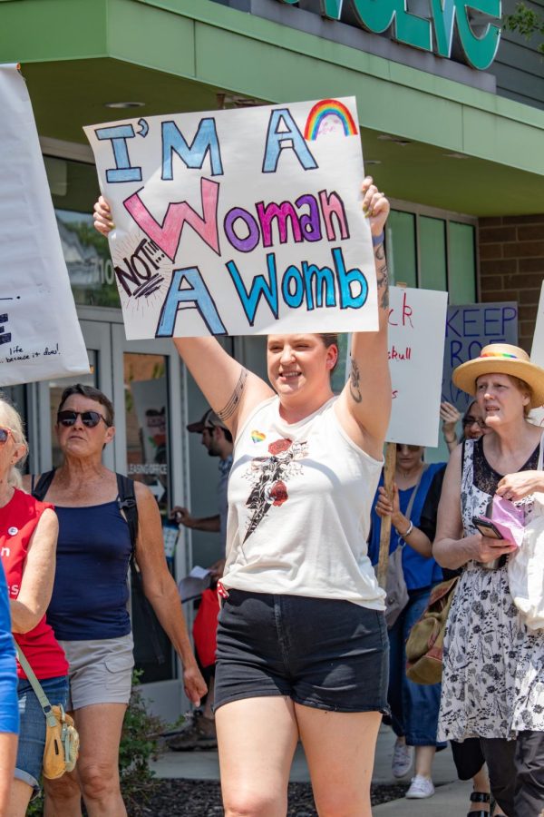 A woman holds a sign that says, Im A Woman Not A Womb, at the Bans Off Our Bodies March May 14, 2022 in Carbondale, Ill. 