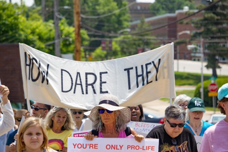 Activists hold a How Dare They banner throughout the Bans Off Our Bodies March May 14, 2022 in Carbondale, Ill. 