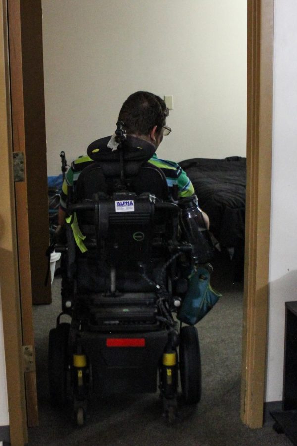 Dean Reece enters his bedroom that has a widened doorway for the wheelchair to move in and out of June 28, 2022 at Heartland Apartments in Carbondale, Ill. 