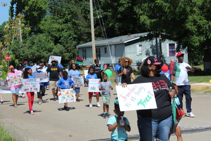 Participants march during the Juneteenth parade hosted by the African American Museum of Southern Illinois June 18, 2022 in Carbondale, Ill. 