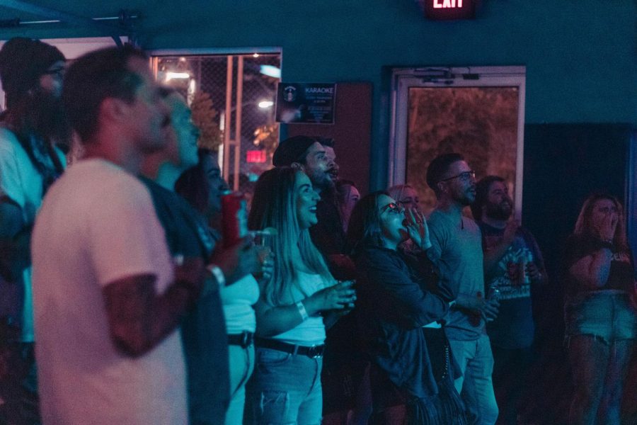 People in the crowd smile and cheer on Isabella while they play their next song July 23, 2022 at Hangar 9 in Carbondale, Ill.