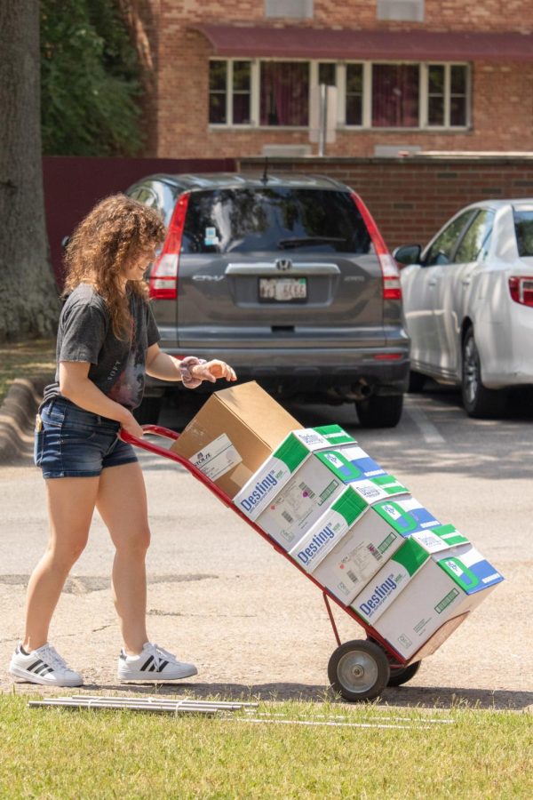 A girl moves boxes into university housing Aug. 19, 2022 in Carbondale, Ill. 