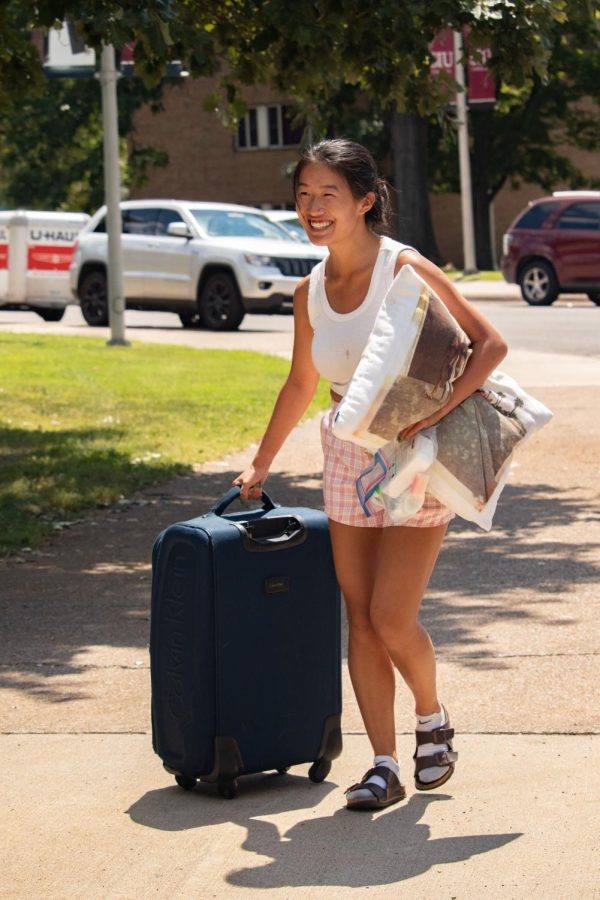 A girl wheels a suitcase into the dorms during SIU move-in Aug. 19, 2022 in Carbondale, Ill. 