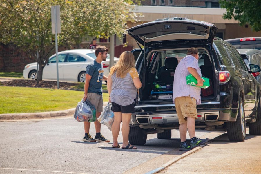A family unpacks their car during move-in Aug. 19, 2022 in Carbondale, Ill. 
