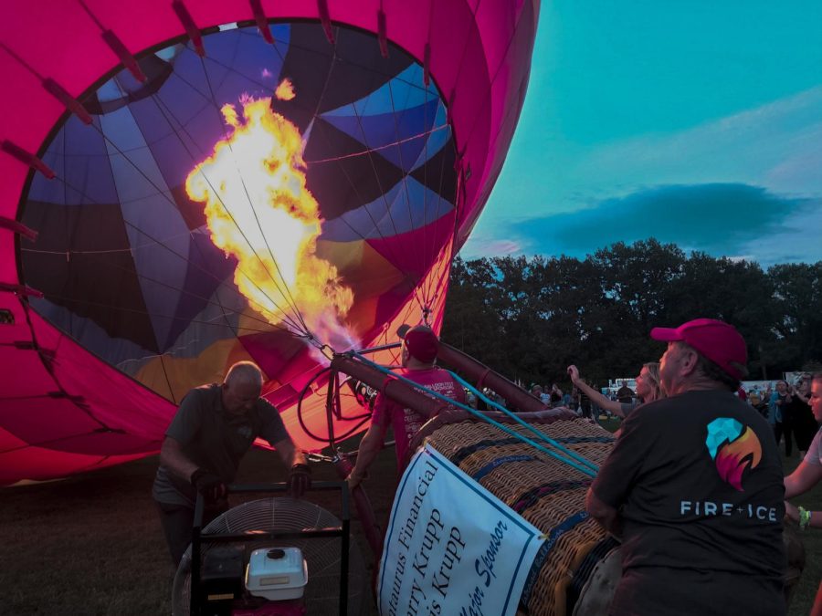 A balloon crew uses a burner to fill one of the hot air balloons with hot air in preparation for the Balloon Glow Aug. 20, 2022 at the Centralia Balloon Festival in Centralia, Ill.

