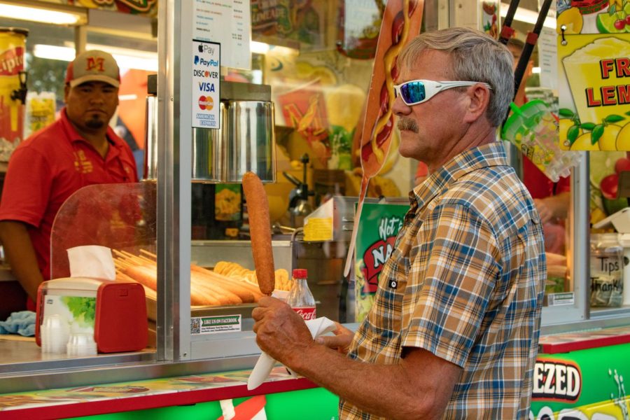 Steve Kuhnert purchases a corn dog at the Du Quoin State Fair Aug. 27, 2022 in Du Quoin, Ill. 
