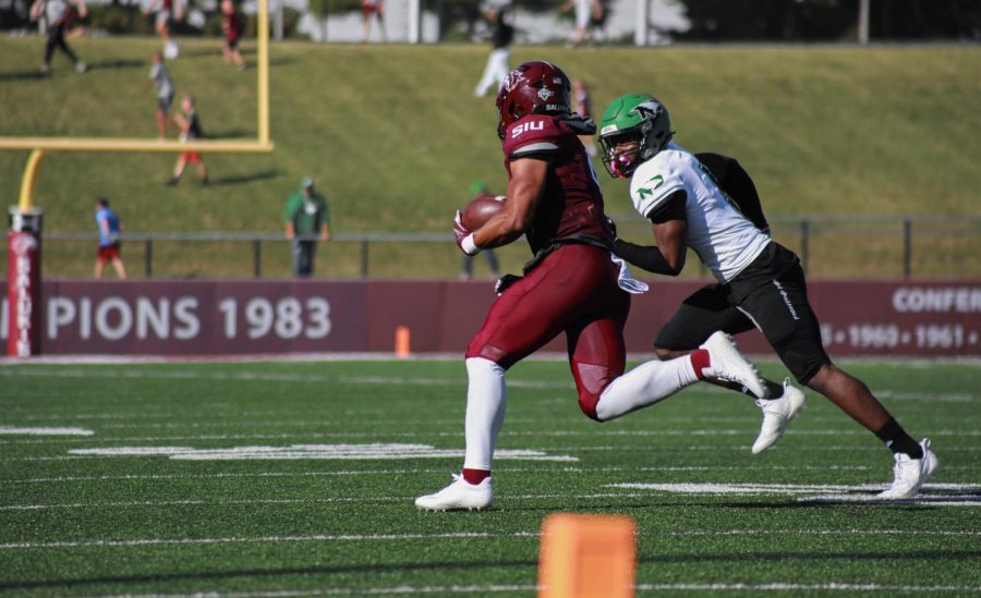 Justin Strong (6) runs down the field with North Dakota’s Clayton Bishop (5) trailing just behind during the family weekend home game Sept. 24, 2022 at Saluki Stadium in Carbondale, Ill.