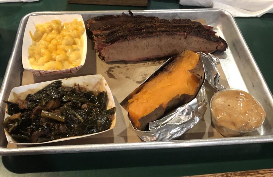 Smoked brisket, macaroni & cheese, collards, and baked sweet potato with cinnamon butter spread sits on a table at 17th Street BBQ Sept. 21, 2022 in Murphysboro, Ill. 