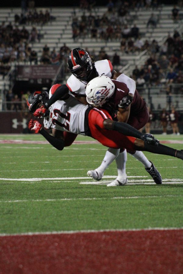 Romeir Elliott (1) takes a hit from two SEMO Redhawks while plowing through towards the end zone, just yards away Sept. 10, 2022 at Saluki Stadium in Carbondale, Ill.