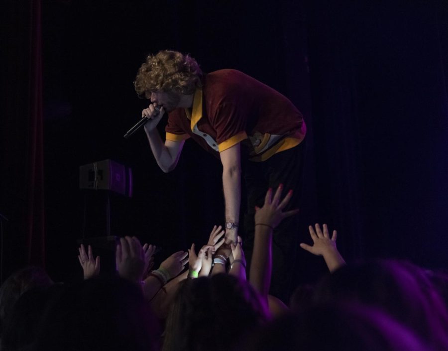 Yung Gravy touches the hands of concert-goers while he performs for SIU crowd Oct. 12, 2022 at Shyrock Auditorium in Carbondale, Ill. 
