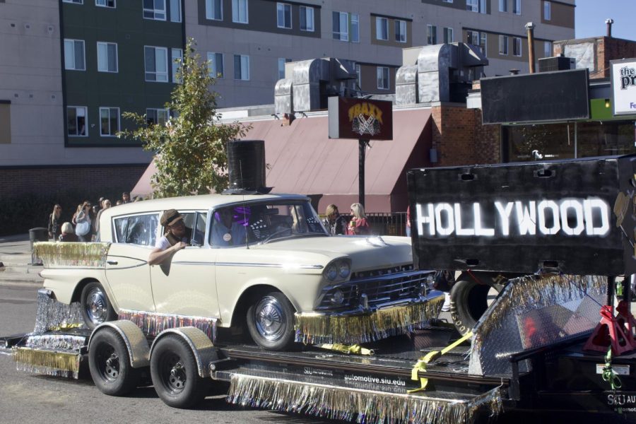 The SIU School of Automotives float cruises by Oct. 15 2022 at the Homecoming Parade in Carbondale, Ill. 