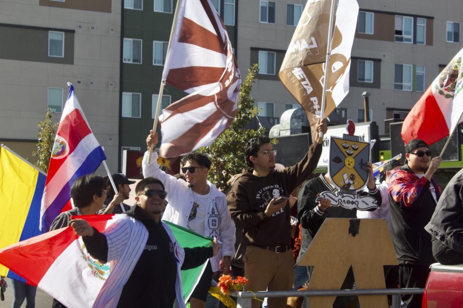 The Leaders of the Latino Greek Movement fly their flags with pride Oct. 15, 2022 at the Homecoming Parade in Carbondale, Ill. 