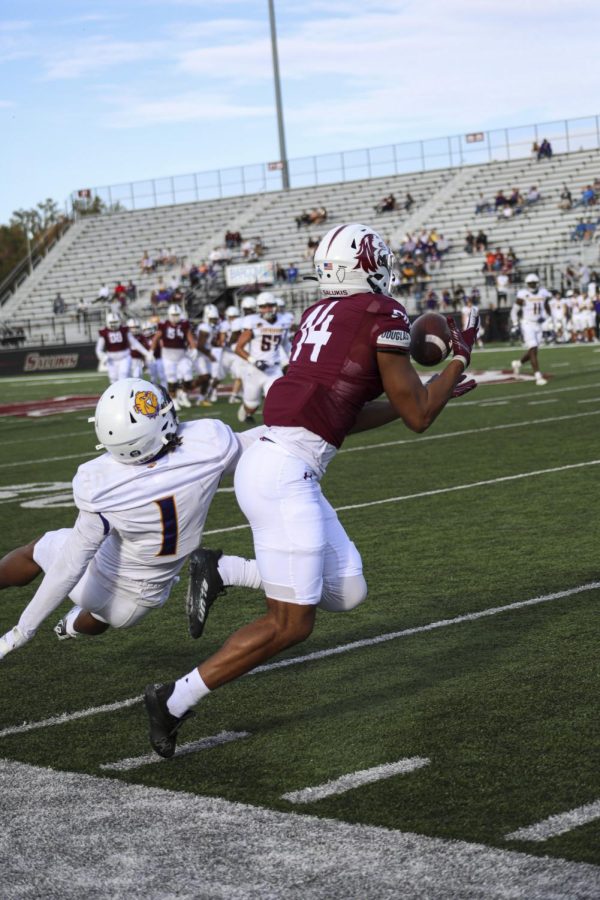 Zach Gibson (14) catches the ball, avoiding Western Illinois JJ Ross (1) during the homecoming game Oct. 15, 2022 at Saluki Stadium in Carbondale, Ill.