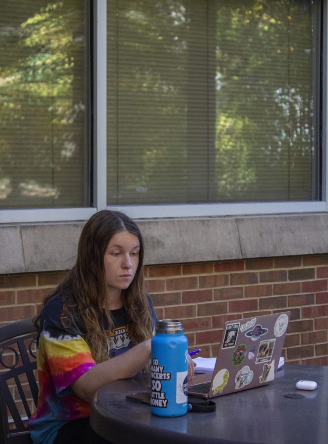 Rebecca Arvold enjoys the weather while she studies outside the Morris library Oct. 20, 2022 at SIU in Carbondale, Ill.