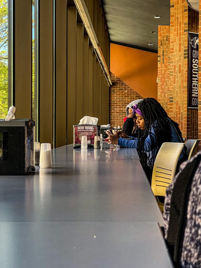 SIU student enjoys her free time between classes Oct. 20, 2022 at True Blood Dining Hall in Carbondale, Ill.