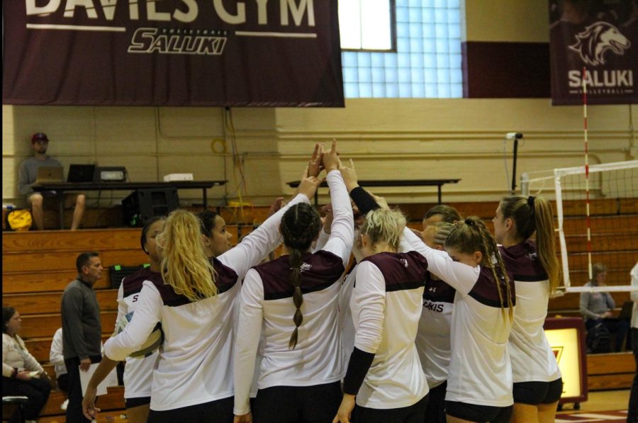 SIU women’s volleyball team does signature group cheer right before the game Oct. 14, 2022 in Davies Gym in Carbondale, Ill. 