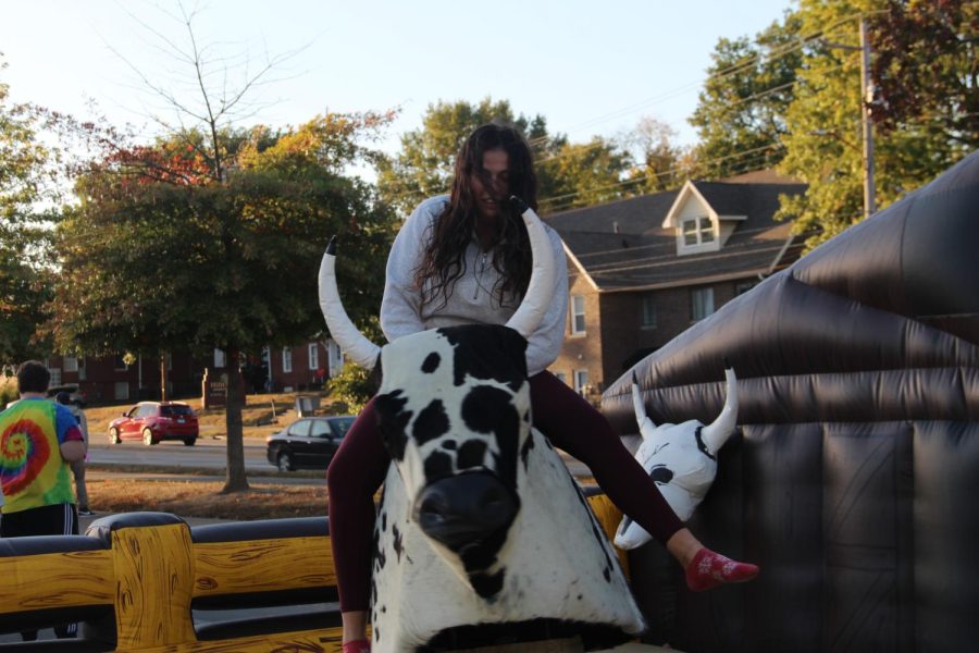 Student rides bull on one of the many rides Oct. 13, 2022 at campus block party in Carbondale, Ill. “I got thrown off so quickly but it was worth the thrill,” Student said.