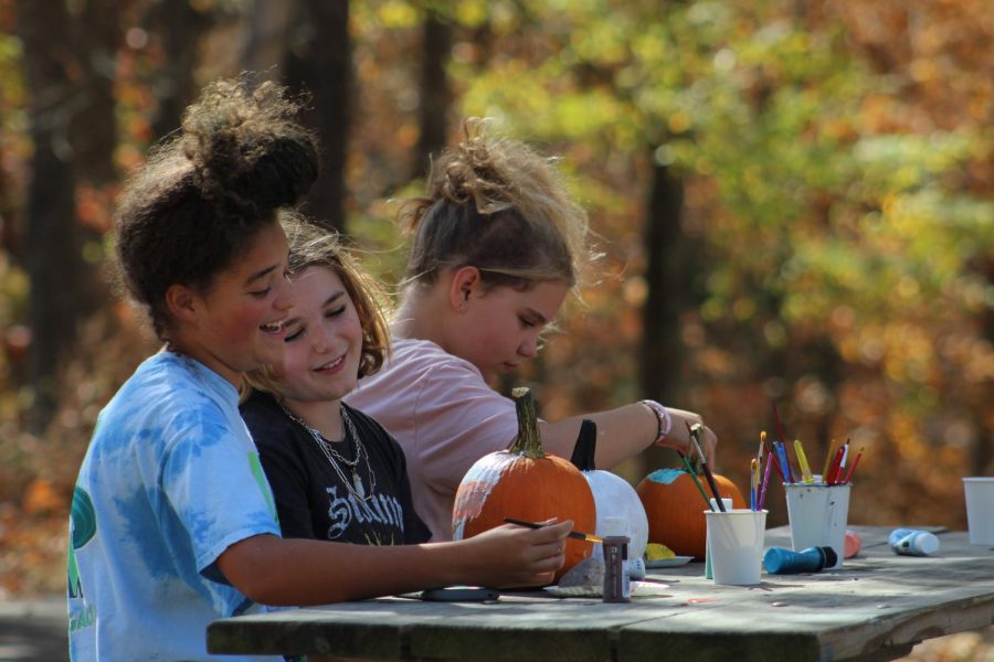 Friends enjoy painting pumpkins at The Haunted Hollow event Oct. 23, 2022 at Touch of Nature in Makanda, Ill. 