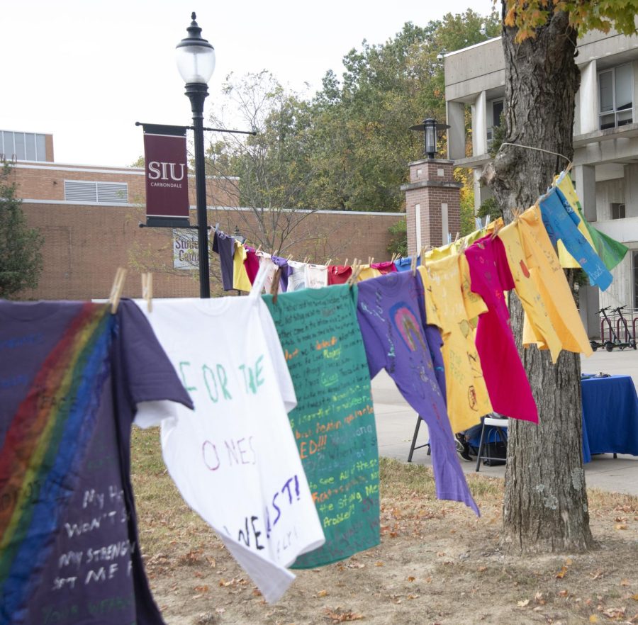 A variety of colored shirts hang across a clothes line in front of Faner Plaza Oct. 11, 2022 at SIU in Carbondale Ill.