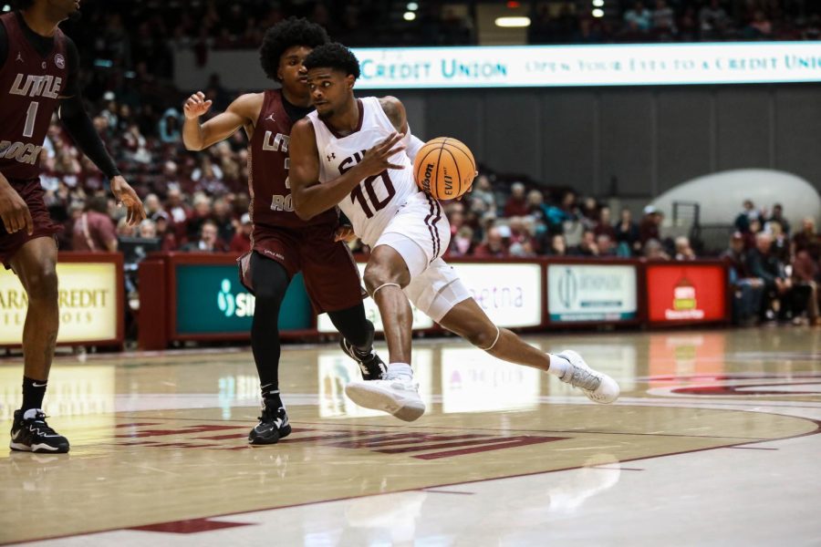 Xavier Johnson (10) drives the ball down the court on offense during the season opener against the Little Rock Trojans Nov. 7, 2022 at the Banterra Center in Carbondale, Ill.