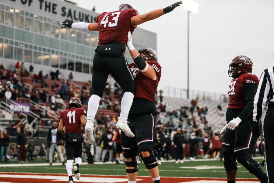 After putting the Salukis in the lead, Jake Green (79) lifts Jacob Garrett (43) in the air to celebrate Garrett’s touchdown against North Dakota State University Nov. 12, 2022 at Saluki Stadium in Carbondale Ill. 