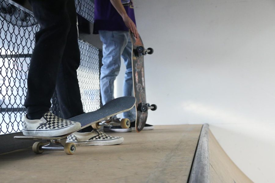 Skaters stand at the top of a ramp  Dec. 2, 2022 at the new indoor skate park in Carbondale, Ill.
