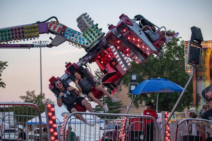 Nick Woodcock (left) and Emma Knapp spin around in an amusement park ride at the Du Quoin State Fair Aug. 27, 2022 in Du Quoin, Ill. 