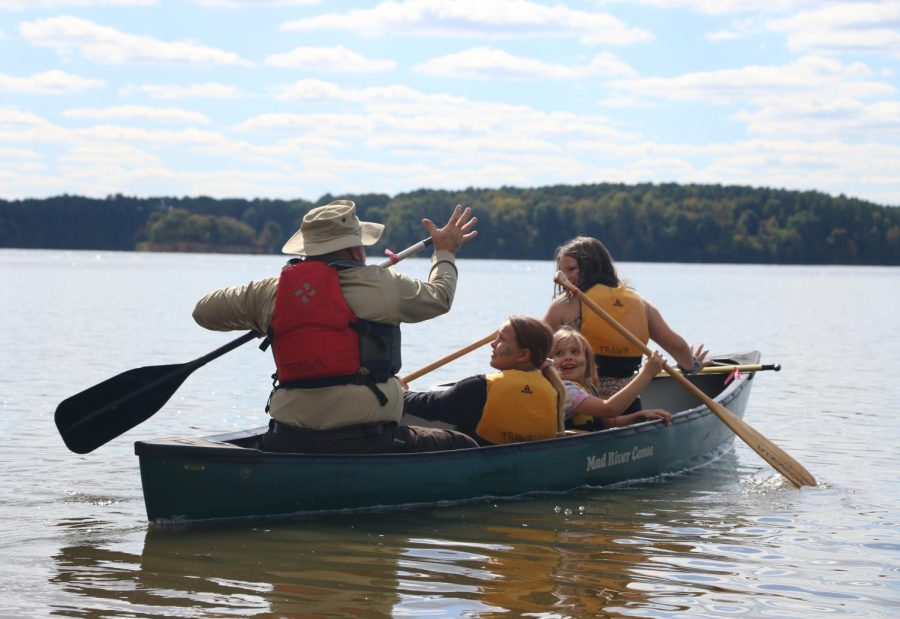 From left, Ranger Bob Dietrich takes passengers Rose Schultz, 9, Lorelai Schultz, 8, and Keneddy Watson, 10, on a short canoe trip on Crab Orchard Lake at the 75th anniversary celebration of Crab Orchard Oct. 8, 2022 at Crab Orchard National Wildlife Refuge in Marion, Ill.
