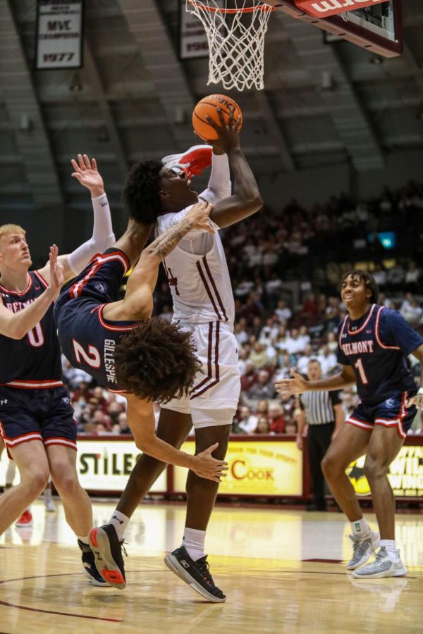 Clarence Rupert (4) knocks Ja’Kobi Gillespie (12) over his shoulder on his approach to the basket against the Belmont University Bruins Jan. 1, 2023 at the Banterra Center in Carbondale, Ill. 