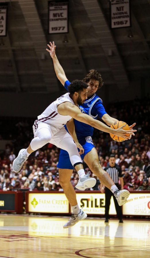 Dalton Banks (3) attempts to pass the ball off while in the air around guarding Drake Bulldog Eric Northweather (35) Jan. 4, 2022 at the Banterra Center in Carbondale, Ill. 