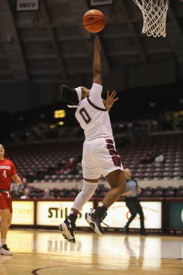 Quierra Love (0) jumps to toss the ball into the basket helping the salukis lengthen their lead against Bradley University Jan. 5, 2023 at the Banterra Center in Carbondale Ill.