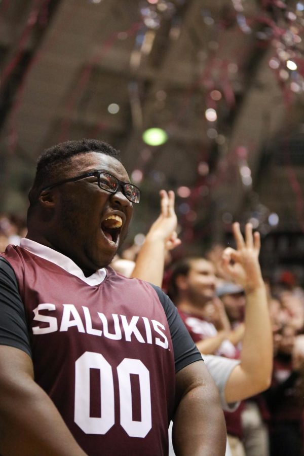 Tyler Lawrence of the Dawg Pound yells in excitement as the Salukis sink the first points of the game causing streamers to rain over the student section Jan. 17, 2022 at Banterra Center in Carbondale, Ill.