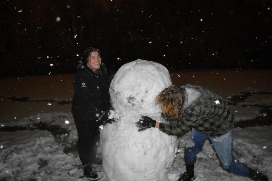 Kaleb Stull and Cheyenne Bristol build a snowman from the heavy snowfall that took place on Tuesday Jan. 24, 2023 in Carbondale, Ill.