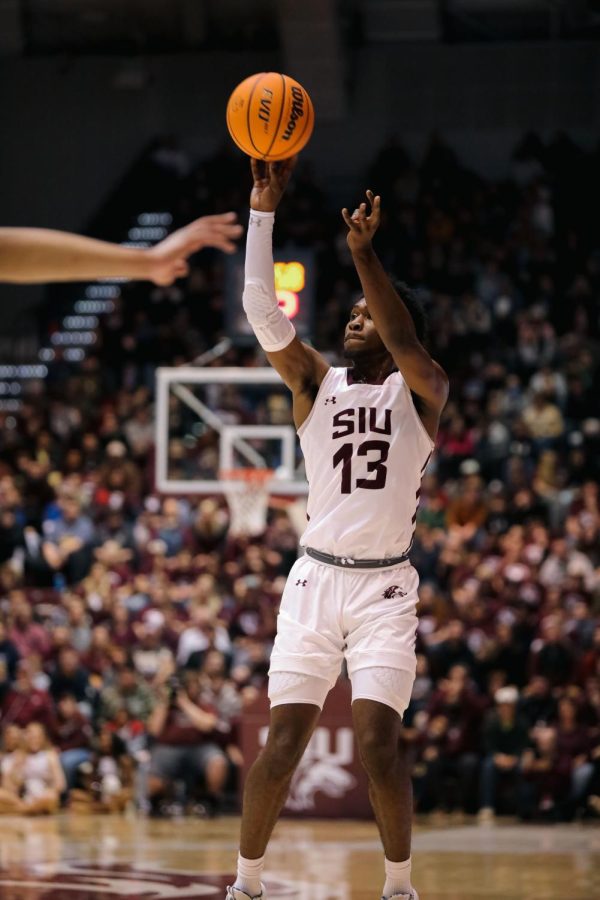 Jawaun Newton (13) shoots from the three against the opposing Racers of Murray State University Jan. 25, 2023 at Banterra Center in Carbondale, Ill.