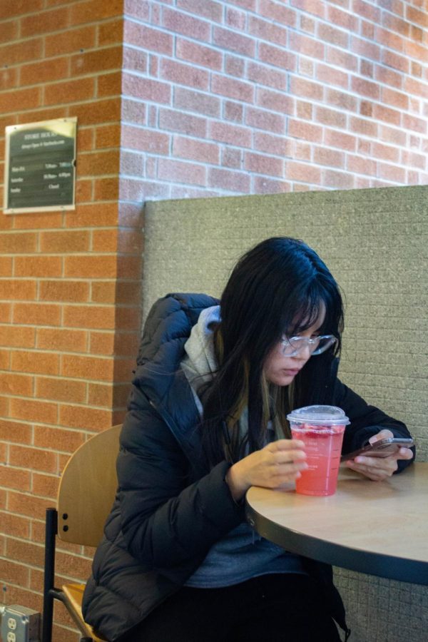 Waewpiach Anuvien, an SIU student, enjoys her drink at Starbucks Jan. 23, 2023 at the Student center at SIU in Carbondale, Ill. “ I really like street fashion.” Anuvien said.