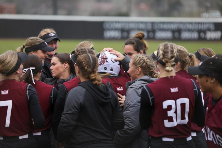 Saluki+Softball+gather+around+home+plate+to+congratulate+Rylie+Hamilton+%281%29+on+her+solo+home+run+which+scored+the+first+points+for+the+Salukis+at+the+Coach+B+Classic+home+opener+tournament+Feb.+26%2C+2023+at+Charlotte+West+Stadium+in+Carbondale%2C+Ill.