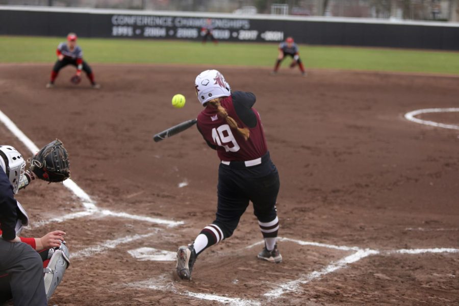 Anna Carder (19) sends the pitch towards the shortstop of Southern Illinois University Edwardsville when the Salukis took on the Cougars at home game Feb. 26, 2023 at Charlotte West Stadium in Carbondale, Ill.