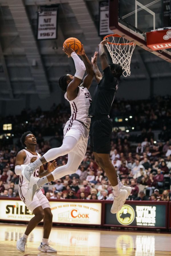Lance Jones (5) jumps up to bring the ball to the basket against Alston Mason (1) of Missouri State Feb. 5, 2022 at Banterra Center in Carbondale, Ill.