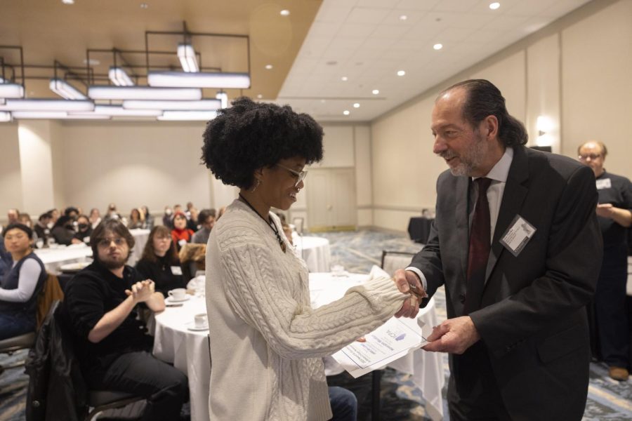 News editor Jamilah Lewis accepts an honorable mention award for best feature story during the ICPA award ceremony Feb. 18, 2023 in Chicago, Illinois. Julia Rendleman | @juliarendleman 