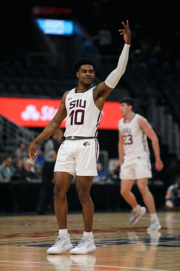 5235: Xavier Johnson (10) holds a three up towards the stands packed with Saluki fans when the Salukis take on the Bears of Missouri State in The Valley tournament Mar. 3, 2023 at the Enterprise Center in St. Louis, Missouri.