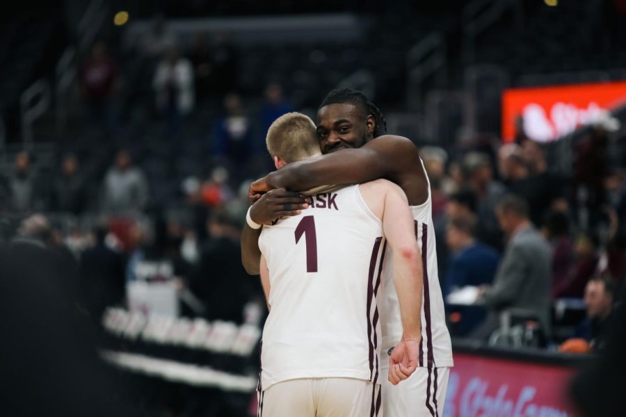 Marcus Domask (1) and J.D Muila (11) share a hug after the Salukis force Missouri State out of the bracket and advance to the Semifinals of the Arch Madness Tournament Mar. 3, 2023 at the Enterprise Center in Saint Louis, MO.