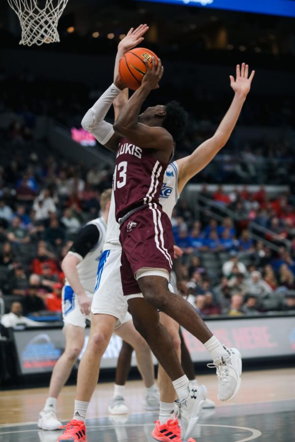 Jawaun Newton (13) gets up towards the basket to score in points as the Salukis take on the Bulldogs of Drake in the Arch Madness Semifinal Mar. 4, 2023 at the Enterprise Center in Saint Louis, MO.