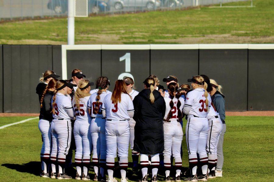 The Salukis huddle-up before the second game of the conference play against the Beacons of Valpo March 17, 2023 at the Charlotte West Stadium in Carbondale, Ill.