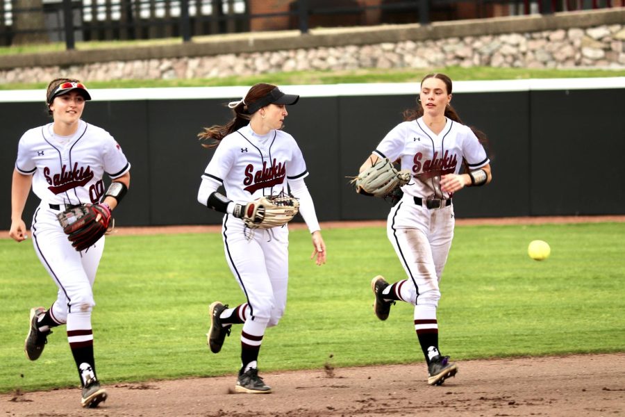 The Salukis return to the dugout after they get the 3rd batsman out in the game against SEMO March 28, 2023 at the Charlotte West Stadium in Carbondale, Ill.