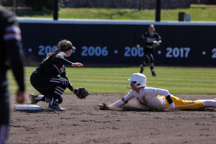 Erin Lee (24) goes down for the tag as Kaiah Fenters (17) of Valparaiso attempts to steal as the Salukis took on the Beacons at home in a weekend series Mar. 19, 2023 at Charlotte West Stadium in Carbondale, Ill. 