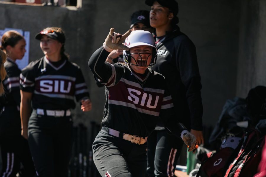 Rylie Hamilton (1) cheers as she walks back into the dugout after putting the Salukis on the board for the first run of the game with her solo home run Mar. 19, 2023 at Charlotte West Stadium in Carbondale, Ill. 