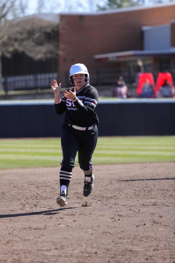 Anna Carder (19) rounds the bases towards home after she hit a two-run home run to help the Salukis sweep the Valparaiso Beacons in their weekend series to stay undefeated at home Mar. 19, 2023 at Charlotte West Stadium in Carbondale, Ill. 