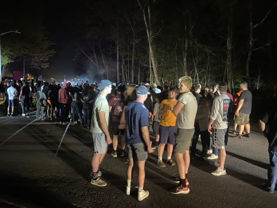 Students gather in Logan Drive outside of the East Campus towers to have a party during the power outage April 13, 2023 in Carbondale, Ill. 