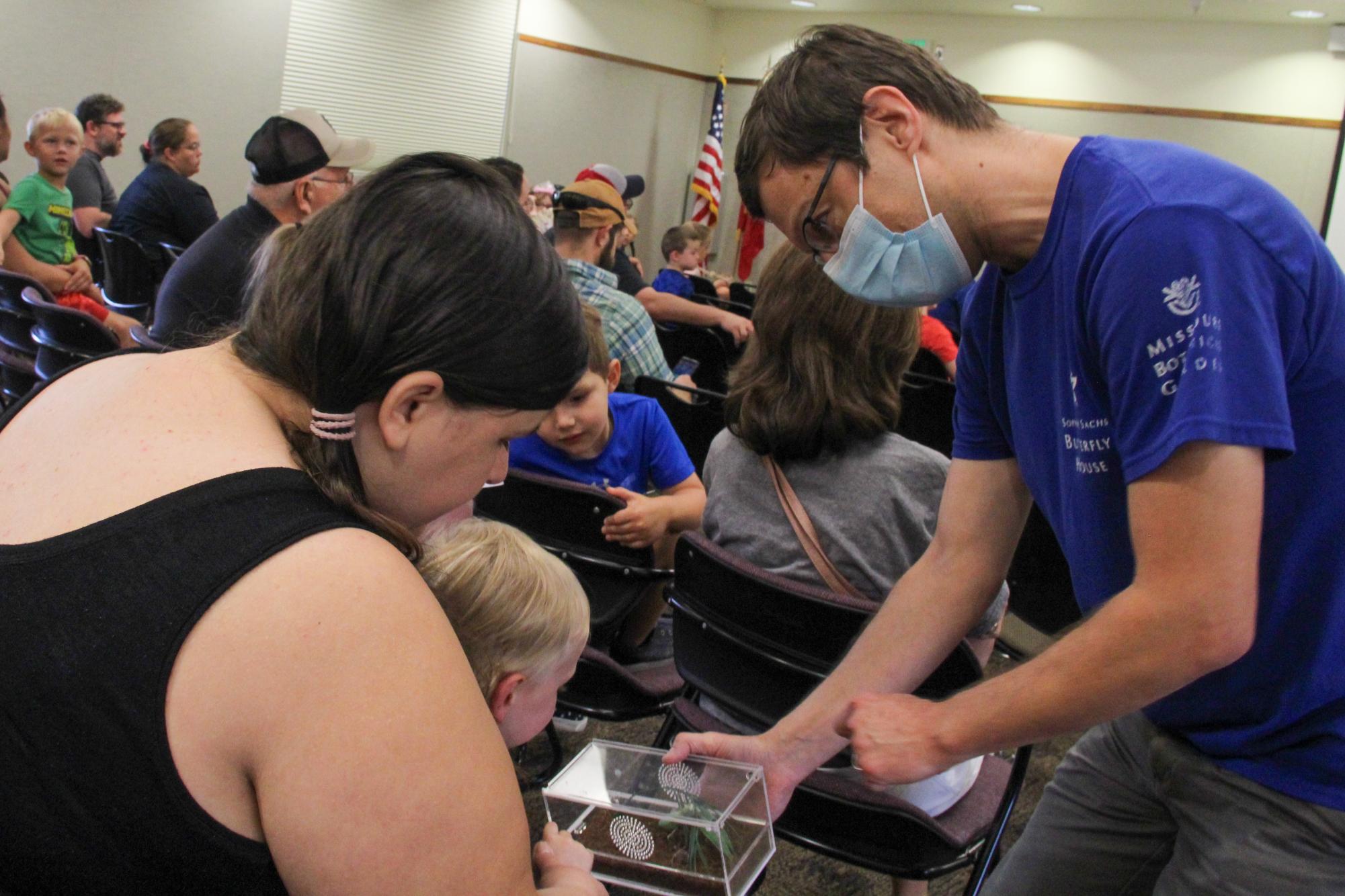 Chris Hartley shows off a praying mantis to a mother and her son at Rend Lake during the Environmental Science Series event September 2, 2023 in Benton, Ill. 